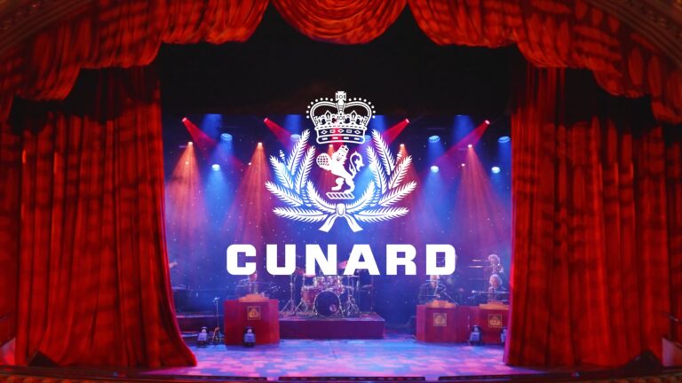 A screen grab from a Cunard video promoting production roles. A stage with red velvet curtains opening to reveal a band set up and lights on stage.